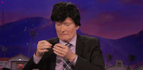 Man putting on a fake mustache